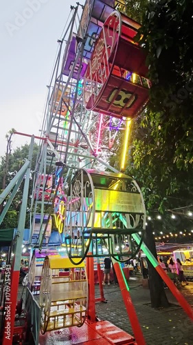 Wallpaper Mural A colorful Ferris wheel with beautiful decorative lights is spinning down. Torontodigital.ca