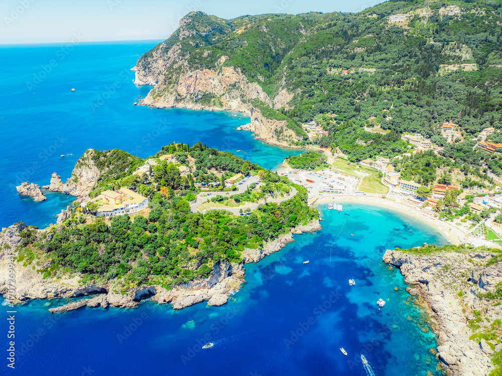 Fototapeta premium Agios Spiridon Beach with crystal azure water and beach with scenery of coastline of Corfu island near Monastery of Paleokastritsa, Ionian sea in Greece