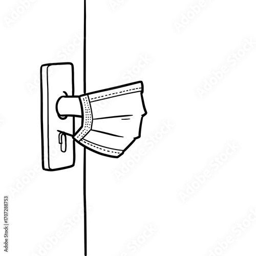 Door handle with a face mask attached, symbolizing health safety  