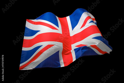 Union Jack flag of the United Kingdom waving on a dark background, symbolizing national pride and identity.