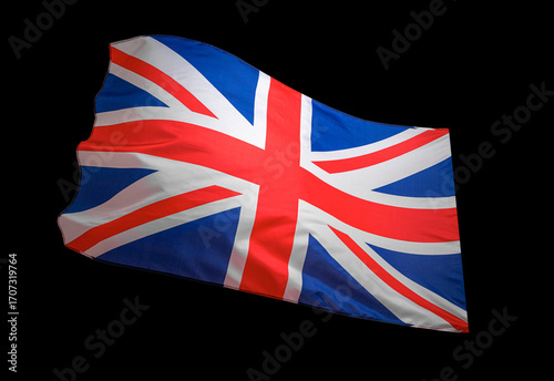 Union Jack flag of the United Kingdom waving on a dark background, symbolizing national pride and identity.