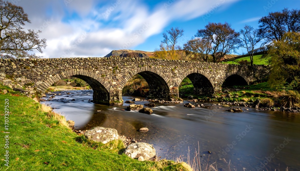 Fototapeta premium Stone arch bridge over a river