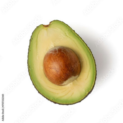 Cut avocado with green skin and shadow