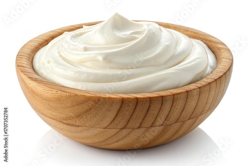 Creamy white yogurt in a wooden bowl isolated on white background