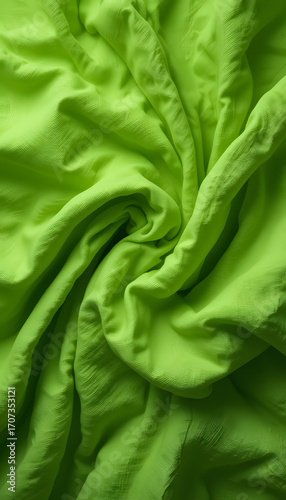 Bright green fabric with organic wrinkle and fold patterns.