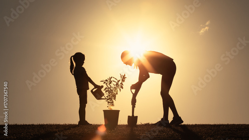 Parent Child Planting a Tree at Sunset, Symbolizing Growth, Help, and Community Spirit