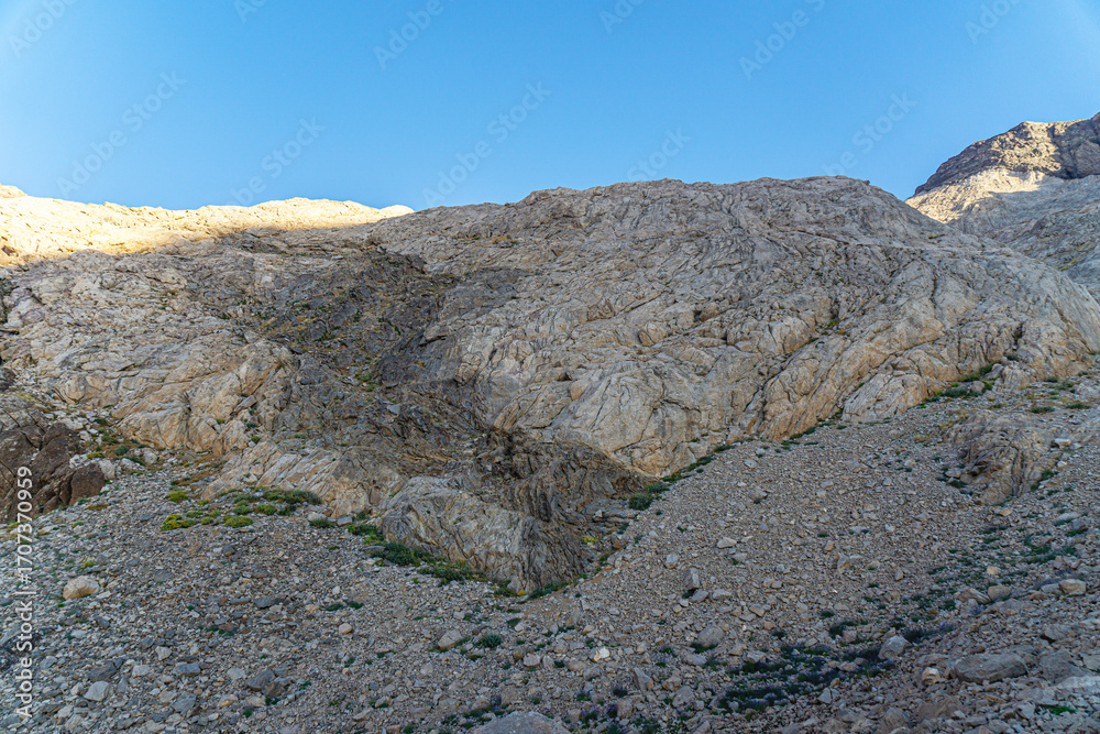 Fototapeta premium The scenic view of Reşko summit in the Sat (Cilo) mountains, Serpel and Horgedim plateau with its glaciers and glacier rivers in Hakkari, Turkey.