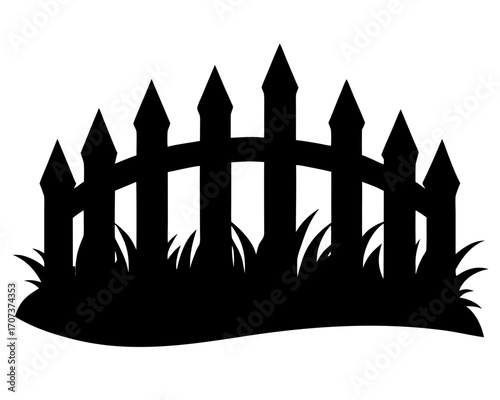 Silhouette of a picket fence with grass