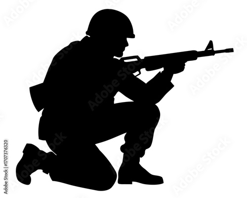 Silhouette of a soldier kneeling with a rifle