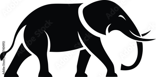 Silhouette of a majestic elephant walking with tusks and trunk raised gracefully