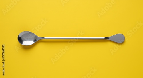 Wallpaper Mural Long Bar Spoon with Stainless Steel, on a Vibrant Yellow Background, and Top View. Torontodigital.ca
