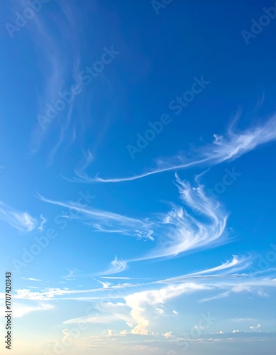 Wispy clouds against a vibrant blue sky