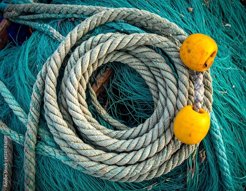 Wallpaper Mural Twisted fishing rope coiled amongst teal fishing nets Torontodigital.ca