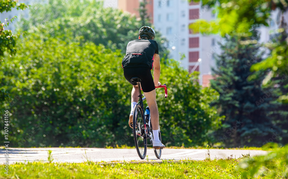 Fototapeta premium Cyclist ride on the bike path in the city Park