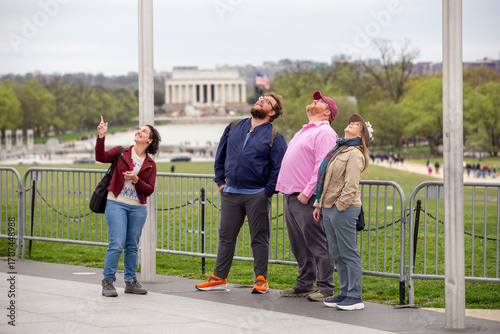 A group of friends looking up at the Washington Monument