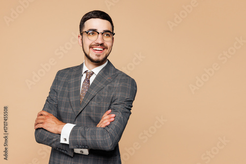Side view young successful employee business man corporate lawyer wear classic formal grey suit shirt tie glasses work in office look aside on area isolated on plain beige background studio portrait.