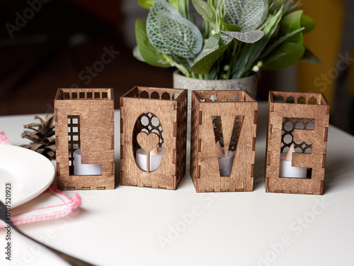 Wooden decorative candlesticks in the form of the word Love