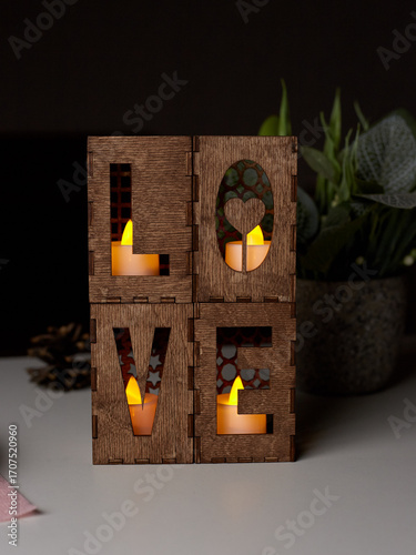 A candle holder in the form of the word love