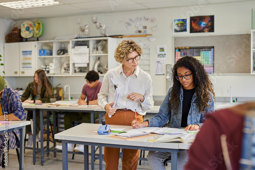 Wallpaper Mural Female teacher helping student at high school class Torontodigital.ca