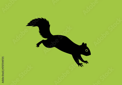 Black squirrel silhouette leaps on a green background