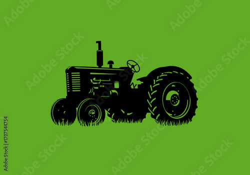Black tractor silhouette on green background tractor is parked in grass
