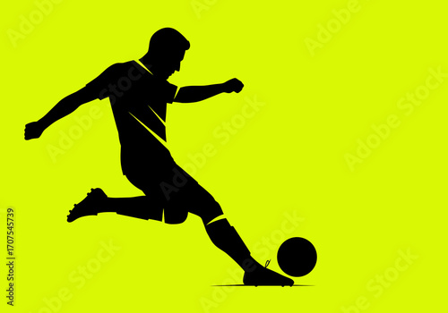 Silhouette of a soccer player kicking a soccer ball