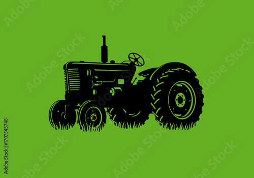 Silhouette of a tractor in black against a green background