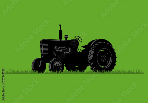 Silhouette of a tractor on grass set against a solid green background