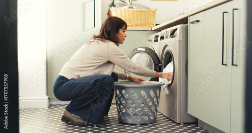 Woman, clothes and washing machine for cleaning in home with basket, fabric and routine for hygiene. Person, container and appliance with laundry, linen or chores with housekeeping at apartment