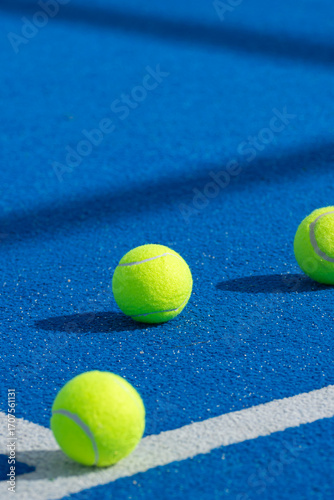 Three yellow tennis balls on a blue padel court The Concept of Sport