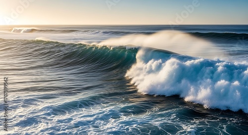 Powerful ocean waves crash against the horizon at sunrise, showcasing a breathtaking display of nature's force and beauty.