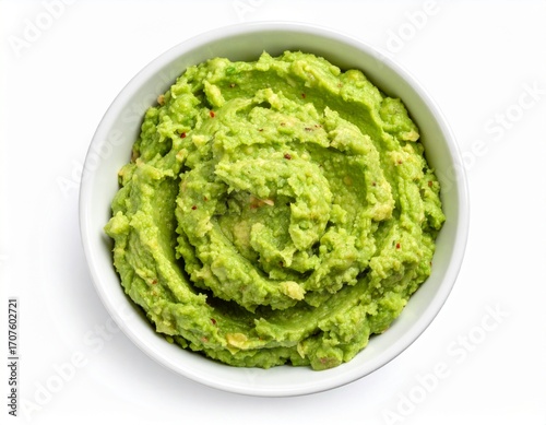 A scoop of mashed avocado in a white bowl, isolated on a white background.
