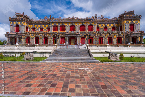 Wallpaper Mural The magnificent, recently restored Kien Trung Palace in Hue, showcasing a vibrant yellow facade, striking red windows, and highly intricate architectural details under a cloudy sky. Torontodigital.ca
