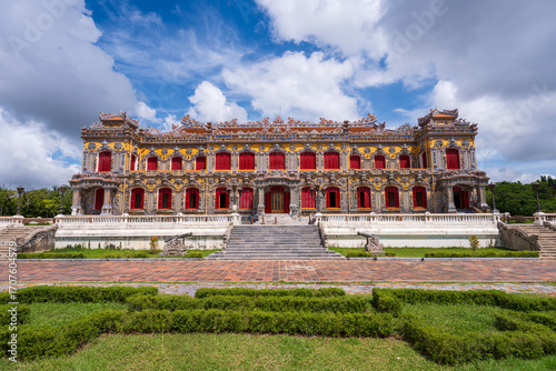 Wallpaper Mural A beautifully restored Kien Trung Palace in Hue, with its vibrant yellow facade, striking red windows, and elaborate rooftop decorations under a cloudy sky. Torontodigital.ca
