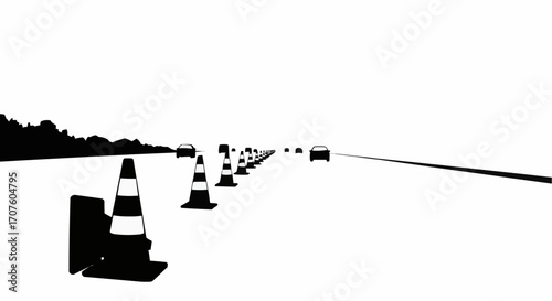 Traffic cones mark a clear road in a monochrome view, symbolizing road safety and control. 