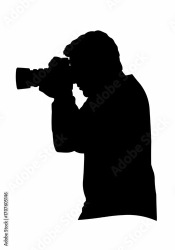 Silhouette of a photographer captured during the act of taking photos.