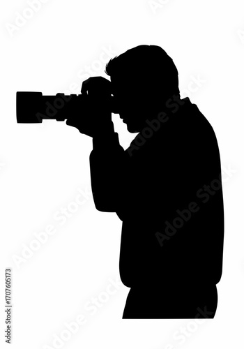 A silhouette of a photographer, focused on capturing a moment with camera in hand. 