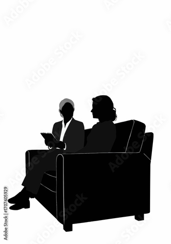 Two figures engaged in a thoughtful discussion while seated on a comfortable sofa.