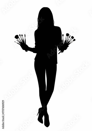 Silhouette of a woman holding makeup brushes.