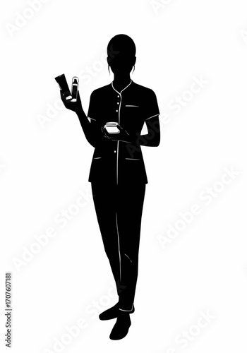 Silhouette of a beauty professional holding skincare products. 