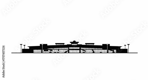 A silhouette of a modern airport terminal against the sky.