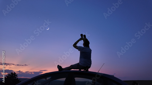 Wallpaper Mural Man watching stars, Milky Way, planets, Moon and other celestial objects from a car rooftop from a dark countryside location. Torontodigital.ca