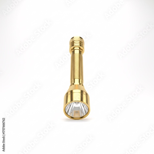 A gold-colored metal flashlight lies on a white surface,