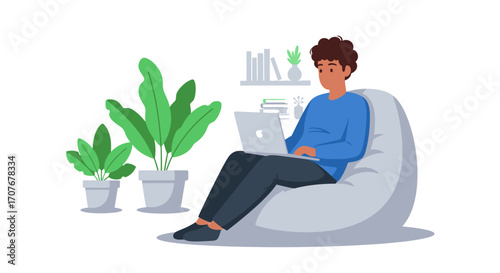 Man Working Remotely on Laptop While Sitting on a Beanbag Chair Surrounded by Plants
