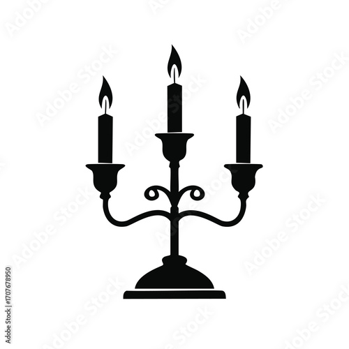 Black silhouette of a three-branched candelabra with lit candles