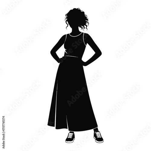 Silhouette of a woman in a long dress with hands on hips
