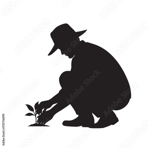 Silhouette of a person wearing a hat, kneeling down and carefully planting a seedling in the soil. Ideal for themes of gardening, agriculture, growth, and nature conservation.