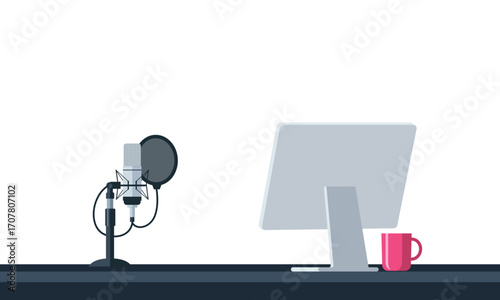 Podcast recording studio setup with microphone computer and coffee mug