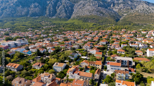 Fototapeta Naklejka Na Ścianę i Meble -  A small town with a beach and a mountain in the background