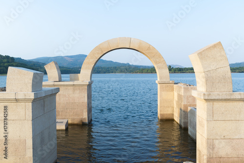 Roman arch of Aquis Querquennis submerged in the lake. Ourense, Spain